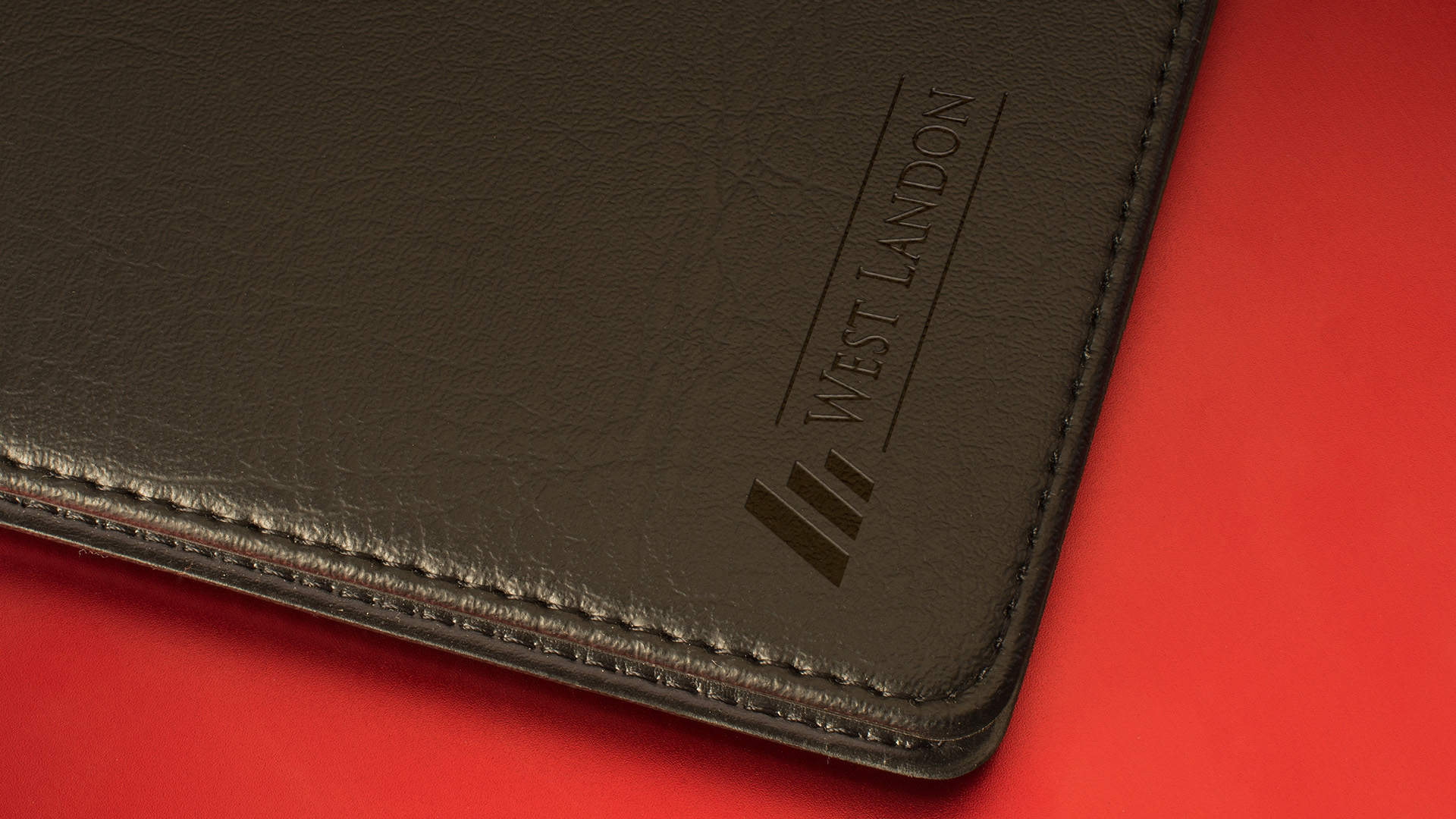 West Landon print logo engraved on leather case.