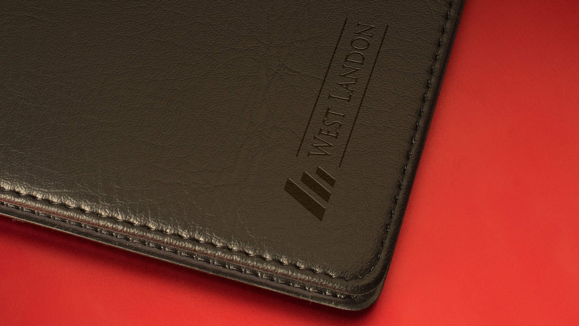 West Landon print logo engraved on leather case.